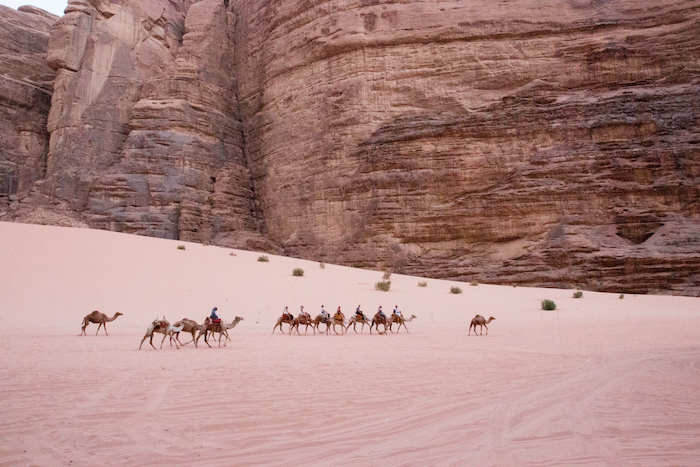Tourists riding camels in Wadi Rum Desert Jordan